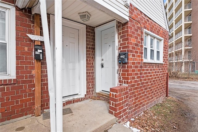 property entrance with brick siding