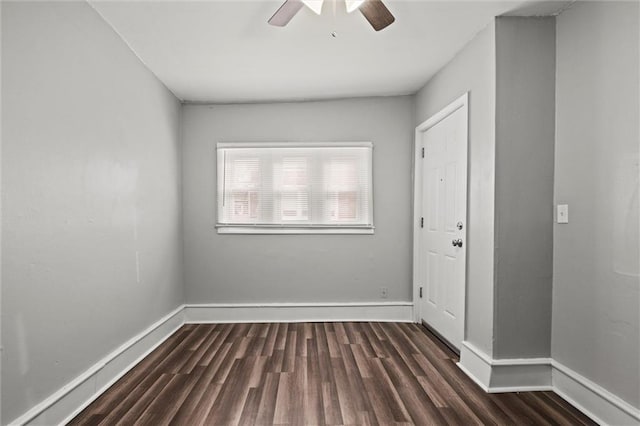 spare room featuring ceiling fan, baseboards, and wood finished floors