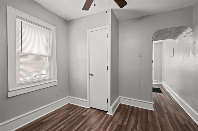 unfurnished bedroom featuring a ceiling fan, baseboards, and wood finished floors