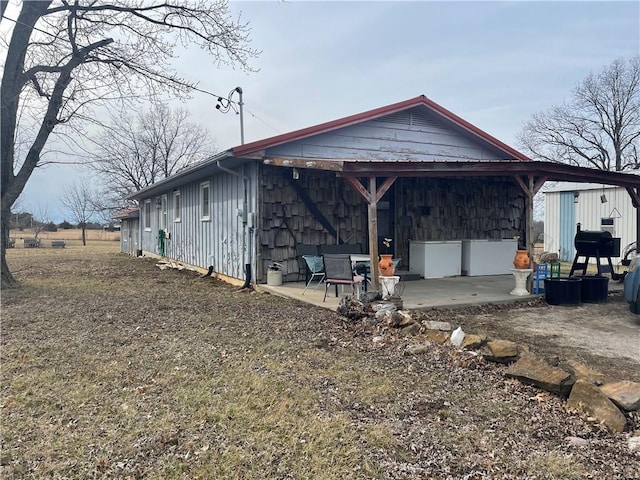 view of property exterior with a patio