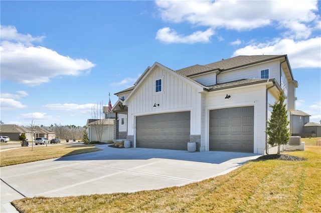 view of property exterior featuring board and batten siding, concrete driveway, roof with shingles, a yard, and an attached garage