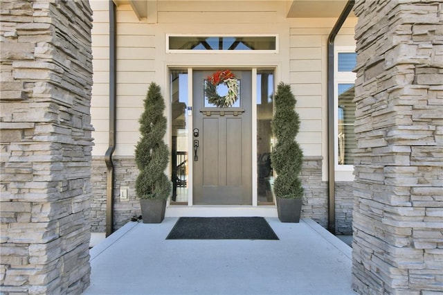 property entrance with stone siding