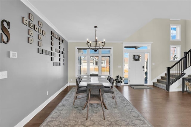 dining area featuring a chandelier, a healthy amount of sunlight, stairs, and dark wood-style flooring