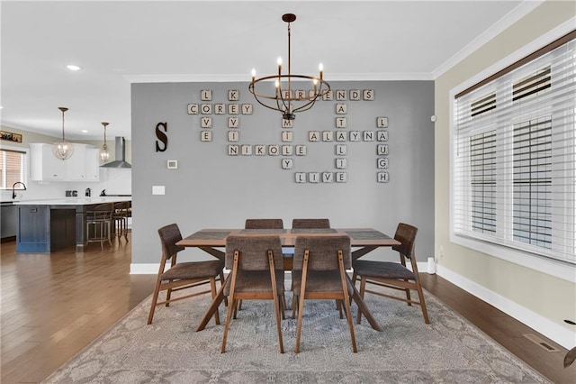 dining area with visible vents, crown molding, dark wood-type flooring, baseboards, and a notable chandelier