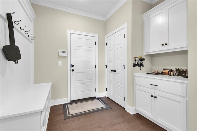 mudroom featuring dark wood-type flooring, baseboards, and ornamental molding