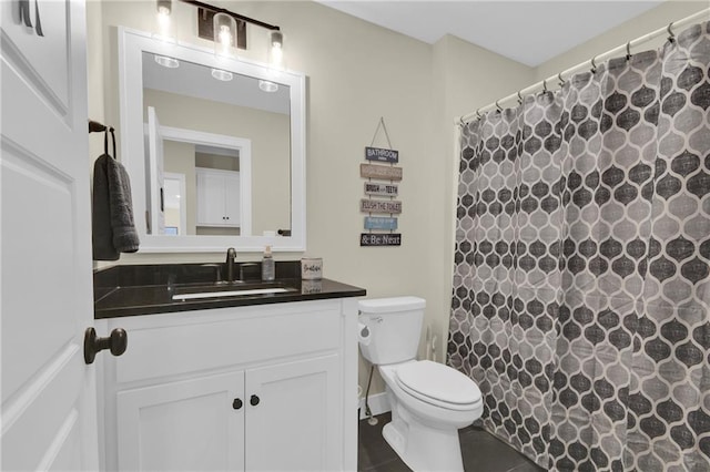 bathroom with tile patterned floors, toilet, vanity, and a shower with curtain