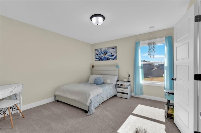 bedroom with baseboards and carpet floors