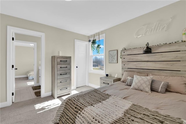 carpeted bedroom featuring baseboards