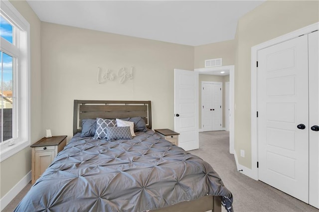 carpeted bedroom with baseboards and visible vents