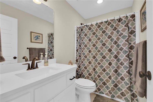 bathroom featuring curtained shower, toilet, and vanity