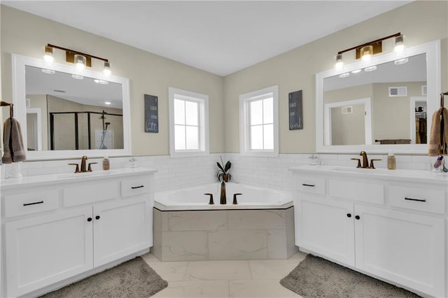 bathroom with a sink, visible vents, a stall shower, and a bath