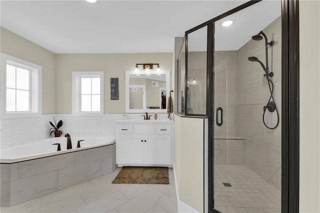 bathroom featuring vanity, a shower stall, a bath, and marble finish floor