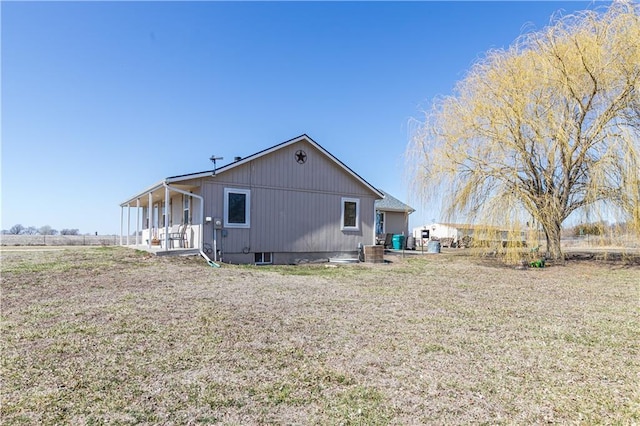 rear view of property with a lawn