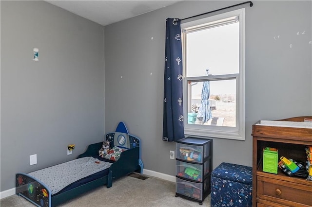 bedroom featuring baseboards and carpet