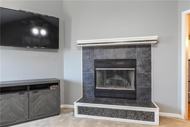 room details featuring carpet flooring, a fireplace, and baseboards