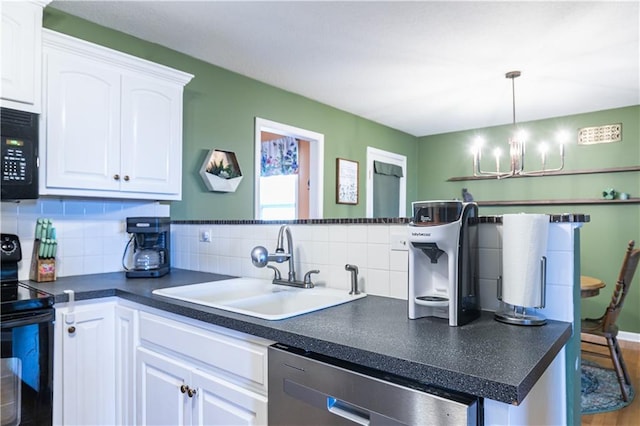 kitchen featuring dark countertops, a notable chandelier, white cabinets, black appliances, and a sink