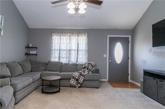 carpeted living room featuring a wealth of natural light, baseboards, ceiling fan, and vaulted ceiling