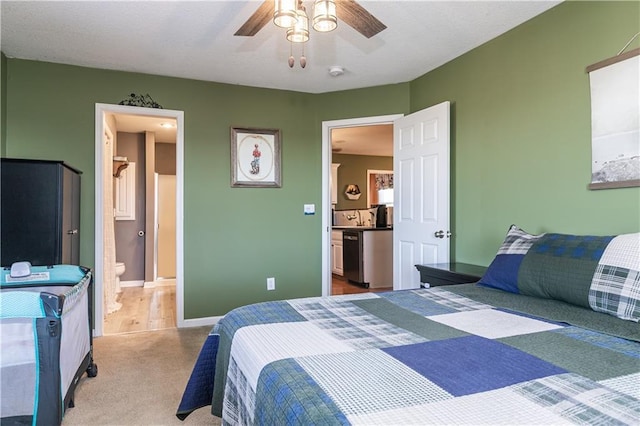 carpeted bedroom with baseboards, ceiling fan, and ensuite bathroom