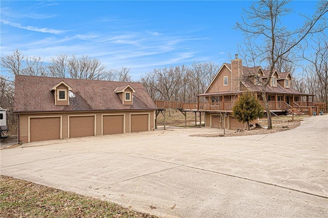 view of side of home with a garage and driveway