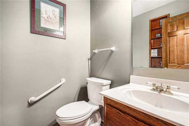 bathroom with toilet and vanity