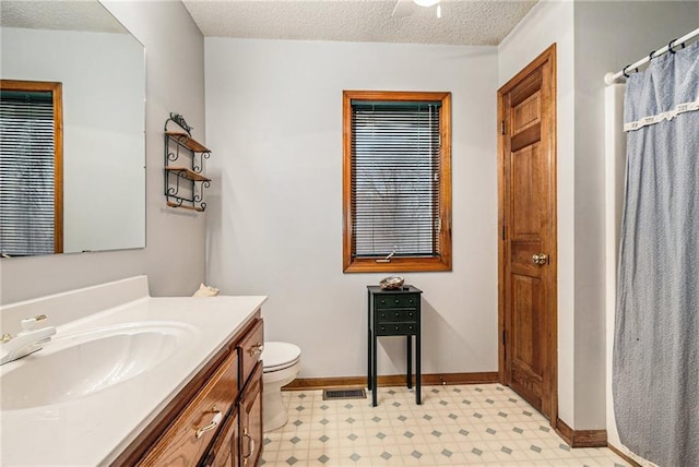 full bath with visible vents, baseboards, toilet, tile patterned floors, and a textured ceiling