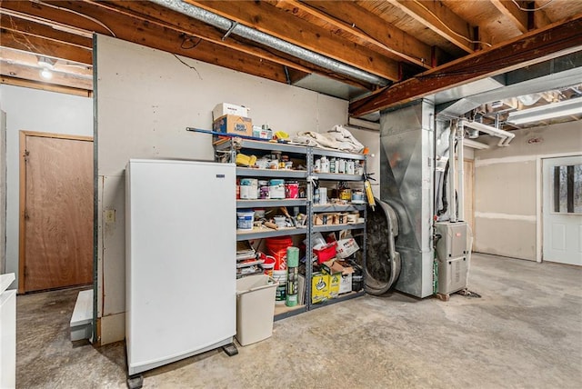 unfinished below grade area featuring freestanding refrigerator