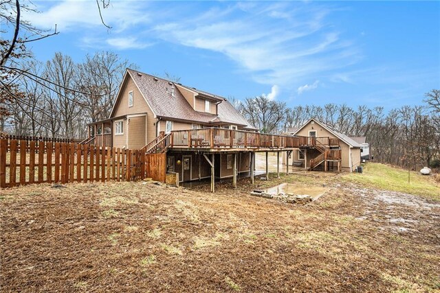 exterior space with stairway, fence, and a wooden deck