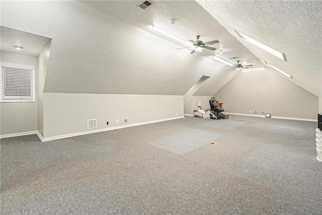 additional living space with visible vents, baseboards, and a textured ceiling