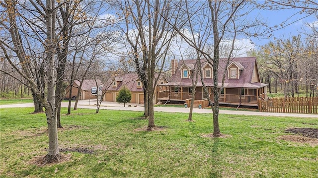 4623 Whispering Oaks Ln, Smithville, MO 64089 - cape cod house featuring a porch, fence, concrete driveway, and a front lawn