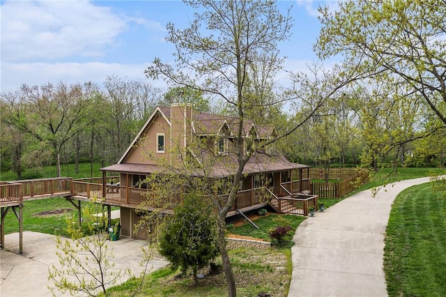 4623 Whispering Oaks Ln, Smithville, MO 64089 - view of home's exterior with a garage, covered porch, a deck, a yard, and driveway