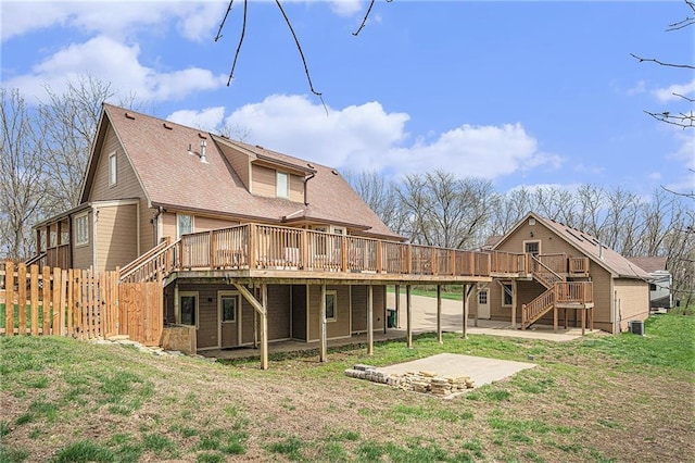 4623 Whispering Oaks Ln, Smithville, MO 64089 - rear view of house with roof with shingles, a wooden deck, stairway, and a patio