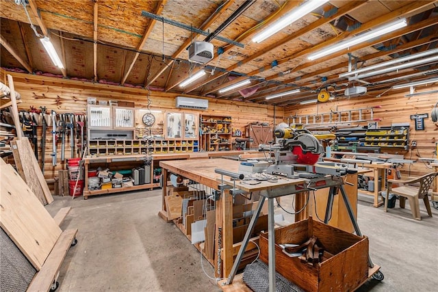4623 Whispering Oaks Ln, Smithville, MO 64089 - miscellaneous room with a workshop area, a wall mounted AC, and concrete flooring