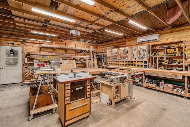 4623 Whispering Oaks Ln, Smithville, MO 64089 - miscellaneous room with concrete flooring, wood walls, a workshop area, and a wall unit AC