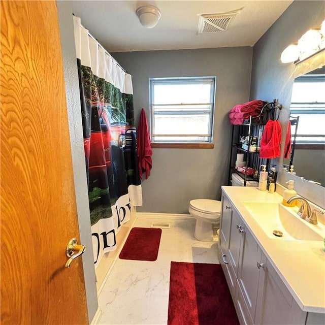 full bath with marble finish floor, visible vents, toilet, vanity, and a shower with curtain