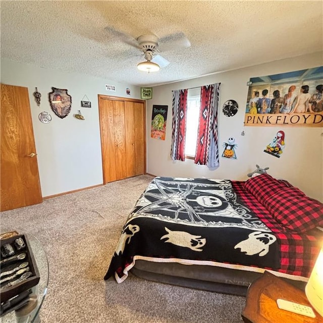 bedroom with carpet floors, a closet, a ceiling fan, a textured ceiling, and baseboards