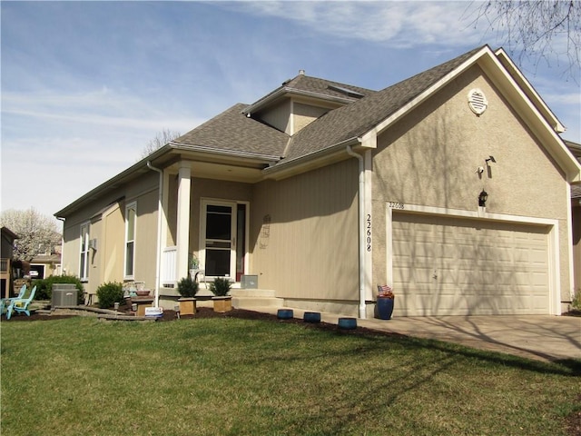 view of property exterior with an attached garage, a lawn, driveway, and central AC unit