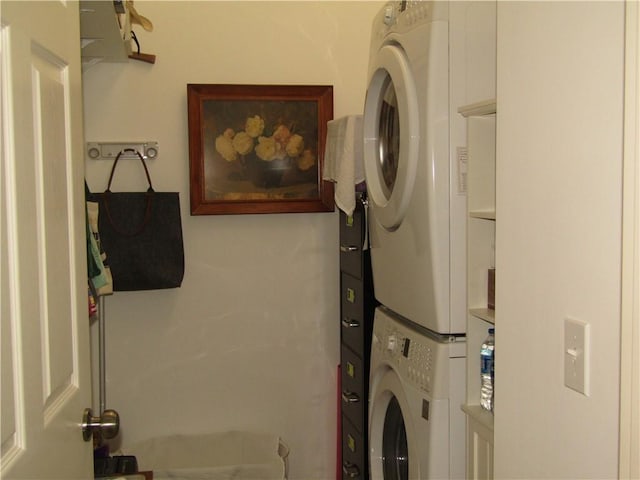 laundry area with stacked washer and clothes dryer and laundry area