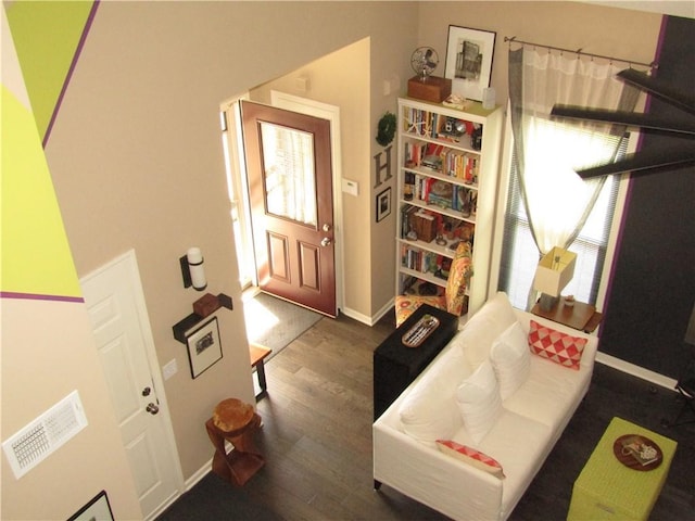 interior space featuring dark wood finished floors, baseboards, and visible vents