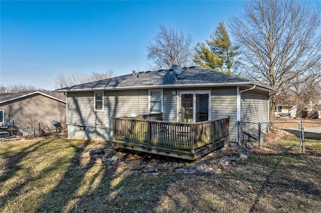 back of property with a wooden deck, fence, a yard, and a gate