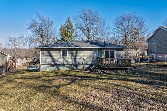 back of property with a lawn, fence, and a wooden deck