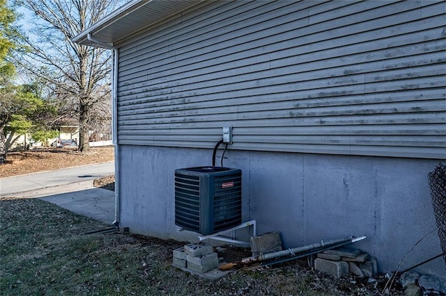 details featuring central AC unit and a wood stove