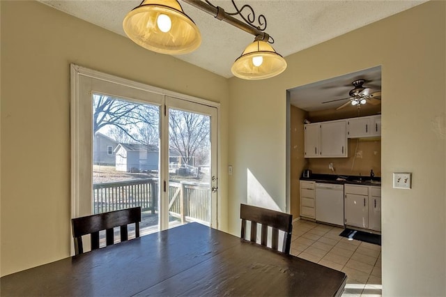 dining space with light tile patterned flooring and a textured ceiling