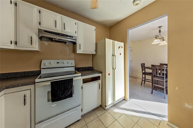 kitchen with under cabinet range hood, white appliances, dark countertops, and light tile patterned floors