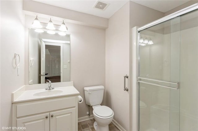 bathroom with visible vents, toilet, a shower stall, baseboards, and vanity