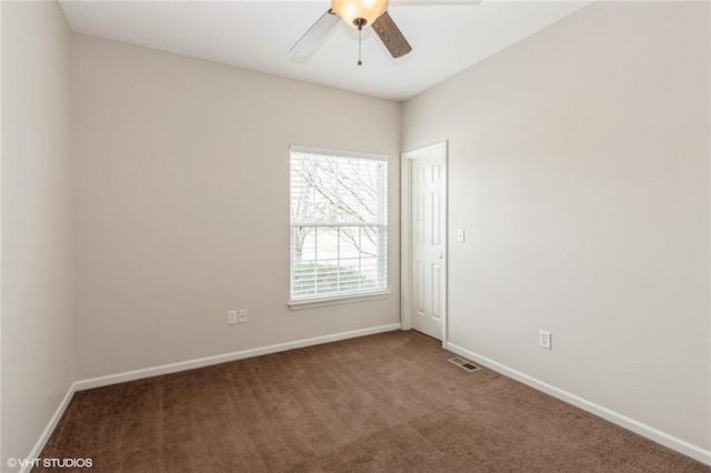 unfurnished room with carpet flooring, visible vents, baseboards, and ceiling fan