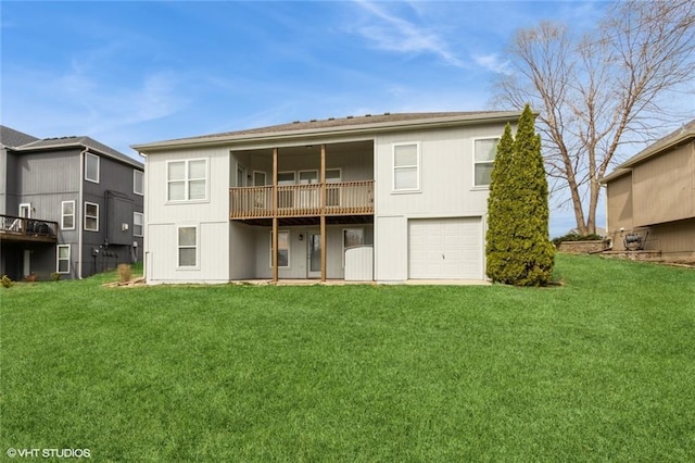 rear view of property with a lawn and a garage