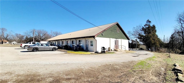 view of side of home with uncovered parking