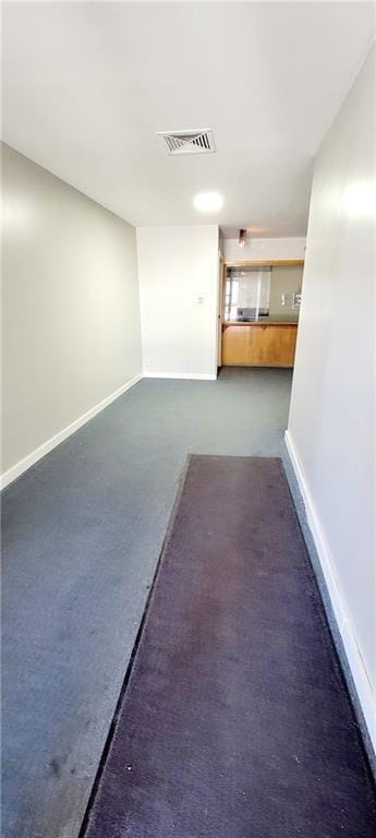 unfurnished living room featuring baseboards and visible vents