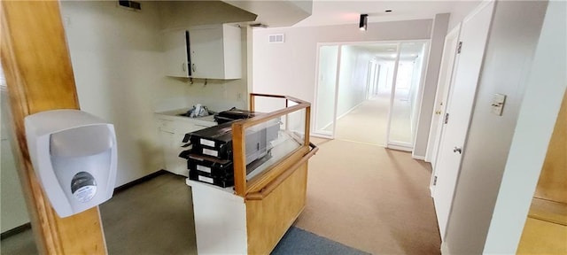 corridor featuring visible vents and light colored carpet