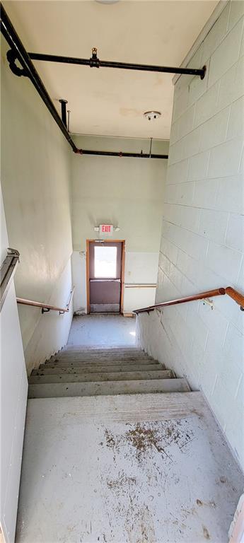staircase with concrete block wall